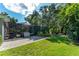 Enjoy this beautiful backyard with screened lanai, lush green lawn, mature trees, and brick paver path at 5927 Flatwoods Manor Cir, Lithia, FL 33547