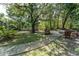 The backyard features a brick paver walkway leading to a fire pit with Adirondack chairs for outdoor entertaining at 5927 Flatwoods Manor Cir, Lithia, FL 33547