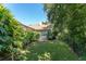The backyard features lush landscaping, a well maintained lawn, and privacy fence for a serene outdoor space at 5927 Flatwoods Manor Cir, Lithia, FL 33547