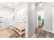 Hallway view of a bathroom featuring a shower with white subway tile and double sink vanity at 5927 Flatwoods Manor Cir, Lithia, FL 33547