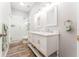 Stylish bathroom featuring white dual sink vanity with marble countertop and glass shower at 5927 Flatwoods Manor Cir, Lithia, FL 33547