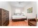 Cozy bedroom featuring a bed, dresser, hardwood floors, and a ceiling fan at 5927 Flatwoods Manor Cir, Lithia, FL 33547