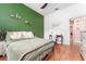 Bedroom featuring hardwood floors, a green accent wall and writing desk at 5927 Flatwoods Manor Cir, Lithia, FL 33547