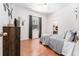 Bedroom featuring hardwood floors, a cozy bed, natural light, and hanging egg chair at 5927 Flatwoods Manor Cir, Lithia, FL 33547