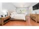 Serene bedroom featuring an upholstered bed, shutters, and a chandelier at 5927 Flatwoods Manor Cir, Lithia, FL 33547