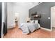 Bedroom with hardwood floors, hanging chair, and a striking gray accent wall at 5927 Flatwoods Manor Cir, Lithia, FL 33547