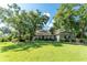 Beautiful single-story home with mature trees shading the lush green lawn, offering curb appeal at 5927 Flatwoods Manor Cir, Lithia, FL 33547