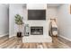 Cozy fireplace with decorative accents, complemented by stylish furnishings and wood flooring at 5927 Flatwoods Manor Cir, Lithia, FL 33547