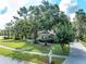 Well-manicured front yard with mature trees and a charming mailbox, enhancing the home's curb appeal at 5927 Flatwoods Manor Cir, Lithia, FL 33547