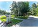 Well-maintained front yard showcasing a mailbox with flower bed in a sunny setting at 5927 Flatwoods Manor Cir, Lithia, FL 33547