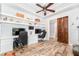 Spacious home office with custom built-in shelving, stylish floors, and ample workspace at 5927 Flatwoods Manor Cir, Lithia, FL 33547