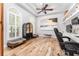 Stylish home office with built-ins, arched windows, and unique flooring for a comfortable workspace at 5927 Flatwoods Manor Cir, Lithia, FL 33547