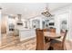 Open-concept kitchen and dining area showcasing an island, breakfast bar, and modern pendant lighting at 5927 Flatwoods Manor Cir, Lithia, FL 33547