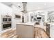 Gourmet kitchen with stainless steel appliances, custom cabinets, and a center island at 5927 Flatwoods Manor Cir, Lithia, FL 33547