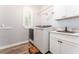 Modern laundry room featuring front load washer and dryer and a utility sink at 5927 Flatwoods Manor Cir, Lithia, FL 33547