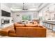Bright living room featuring a brick fireplace, coffered ceilings, and large sectional sofa at 5927 Flatwoods Manor Cir, Lithia, FL 33547