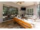 The outdoor living space features comfortable seating, a ceiling fan, and views of the lush backyard and pool at 5927 Flatwoods Manor Cir, Lithia, FL 33547