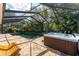 Enclosed pool and spa with stone decking and tropical plants at 5927 Flatwoods Manor Cir, Lithia, FL 33547