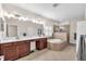 Bright bathroom features a double sink vanity, a soaking tub, and a glass enclosed shower at 6207 Bleeker St, Riverview, FL 33578