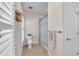 Neutral bathroom with a toilet, shower with a whale-themed curtain, towel rack, and a woven basket for storage at 6207 Bleeker St, Riverview, FL 33578