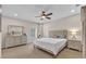 Bright bedroom featuring neutral tones, a ceiling fan, and a comfortable bed with matching nightstands at 6207 Bleeker St, Riverview, FL 33578