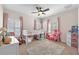 A playful bedroom featuring a white bed with pink curtains and colorful decorations at 6207 Bleeker St, Riverview, FL 33578