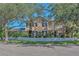 Charming two-story home with a white picket fence, front porch, and well-manicured landscaping at 6207 Bleeker St, Riverview, FL 33578