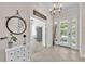 Elegant foyer with tile flooring, a decorative mirror, and a view into the adjacent living spaces at 6207 Bleeker St, Riverview, FL 33578