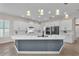 Modern kitchen featuring white cabinets, a gray island, stainless steel appliances, and ample counter space at 6207 Bleeker St, Riverview, FL 33578