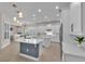 Bright kitchen with white cabinets, island, pendant lighting, and modern appliances, perfect for cooking at 6207 Bleeker St, Riverview, FL 33578