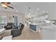 Open-concept kitchen with a large island, stainless steel appliances and modern pendant lighting at 6207 Bleeker St, Riverview, FL 33578