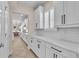 Stylish kitchen showcasing white cabinets, sleek hardware, subway tile backsplash, and modern appliances at 6207 Bleeker St, Riverview, FL 33578