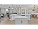 Spacious open kitchen with an island, white cabinetry, and seamless flow into the living and dining areas at 6207 Bleeker St, Riverview, FL 33578