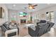 Living room with a fireplace, ceiling fan, and sliding doors to the outside patio at 6207 Bleeker St, Riverview, FL 33578