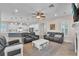 Spacious living room with a ceiling fan, tile flooring, and plenty of natural light at 6207 Bleeker St, Riverview, FL 33578