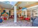 Covered patio with a TV, outdoor seating, and a playful playhouse in an inviting backyard at 6207 Bleeker St, Riverview, FL 33578