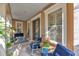 Comfortable front porch with cozy seating, creating an inviting and relaxing outdoor space at 6207 Bleeker St, Riverview, FL 33578