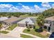 Aerial view of a home with solar panels, a well-manicured lawn, and mature landscaping at 6351 Desert Peace Ave, Land O Lakes, FL 34639