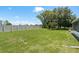 Serene fenced-in backyard with lush lawn and mature trees at 6351 Desert Peace Ave, Land O Lakes, FL 34639