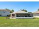 Backyard featuring a patio with a fire pit and a screened-in lanai at 6351 Desert Peace Ave, Land O Lakes, FL 34639