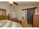 Bedroom featuring barn door to bathroom with vanity and linen closet at 6351 Desert Peace Ave, Land O Lakes, FL 34639
