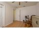 Bright bedroom featuring a ceiling fan, wood laminate floors, a rocking chair and neutral paint at 6351 Desert Peace Ave, Land O Lakes, FL 34639
