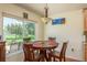 Cozy dining area with wood table and chairs next to a large window overlooking backyard at 6351 Desert Peace Ave, Land O Lakes, FL 34639