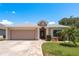 Charming single-story home featuring a two car garage, brick walkway, and well maintained lawn at 6351 Desert Peace Ave, Land O Lakes, FL 34639