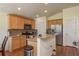 Bright kitchen features wood cabinets, stainless steel appliances and a granite countertop island at 6351 Desert Peace Ave, Land O Lakes, FL 34639