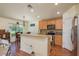 The kitchen features a breakfast bar with granite countertops, stainless appliances, and wood cabinetry at 6351 Desert Peace Ave, Land O Lakes, FL 34639