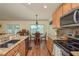 Sunlit kitchen featuring granite counters, stainless appliances, with open dining area at 6351 Desert Peace Ave, Land O Lakes, FL 34639