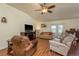 Relax in the living room with a vaulted ceiling, ceiling fan, laminate flooring, and a view of the lanai at 6351 Desert Peace Ave, Land O Lakes, FL 34639