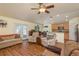 Open-concept living area with vaulted ceilings, wood-look floors, and easy access to the kitchen at 6351 Desert Peace Ave, Land O Lakes, FL 34639