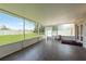 Enclosed patio featuring tile floors, white framed screening and overlooking the fenced backyard at 6351 Desert Peace Ave, Land O Lakes, FL 34639